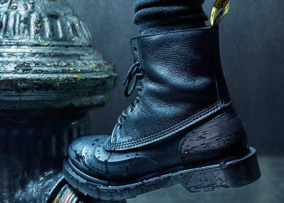 Close-up of a black leather winter boot in a cold, wet environment, illustrating the conditions that can contribute to moisture build-up inside winter footwear.