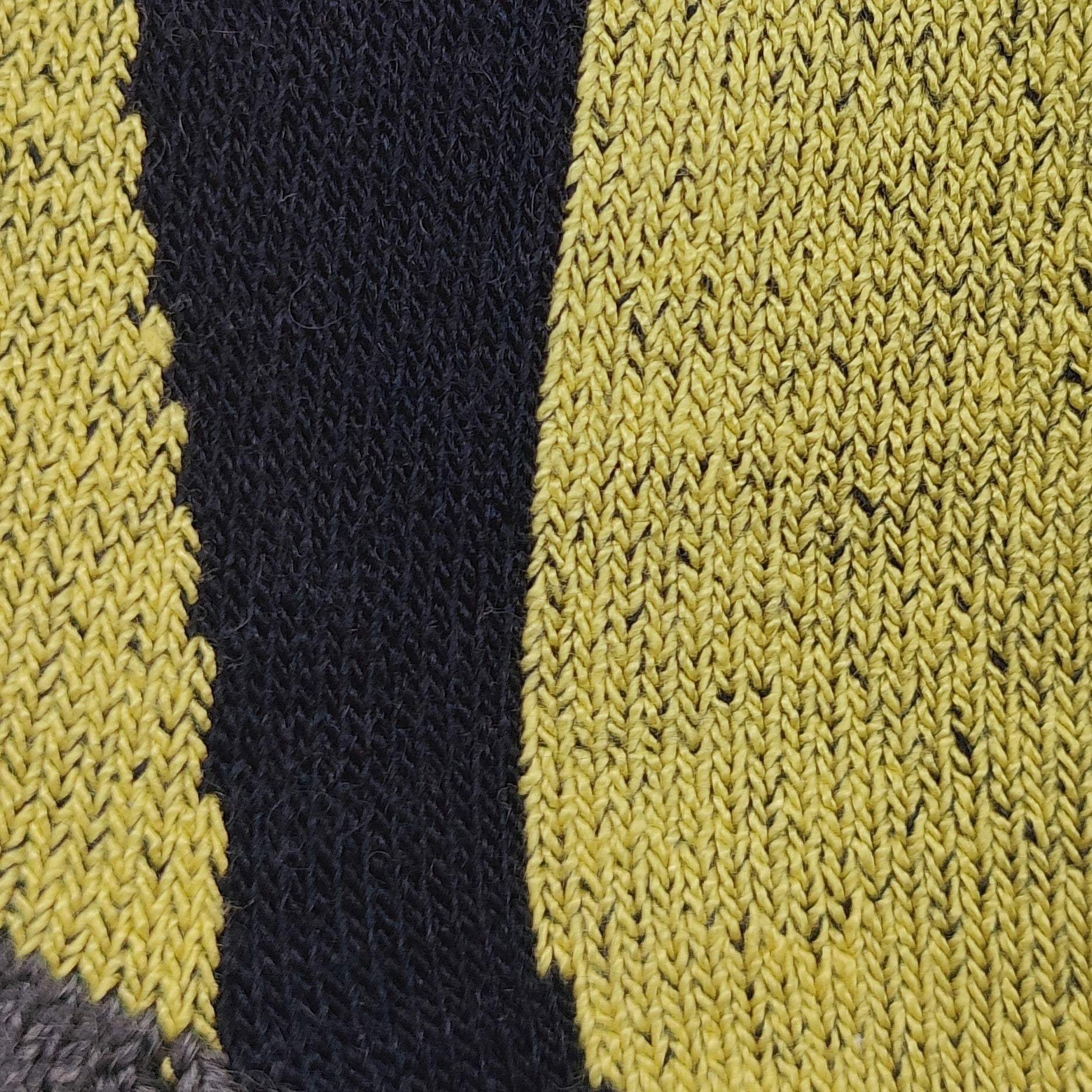 Close-up fabric detail of Laetts men’s Light Snowboard BootGlide™ socks, showing the yellow BootGlide™ low-friction zone, dark navy Merino wool panel, and gray reinforcement. Texture highlights patented BootGlide™ technology and HygroHeat™ warmth system.