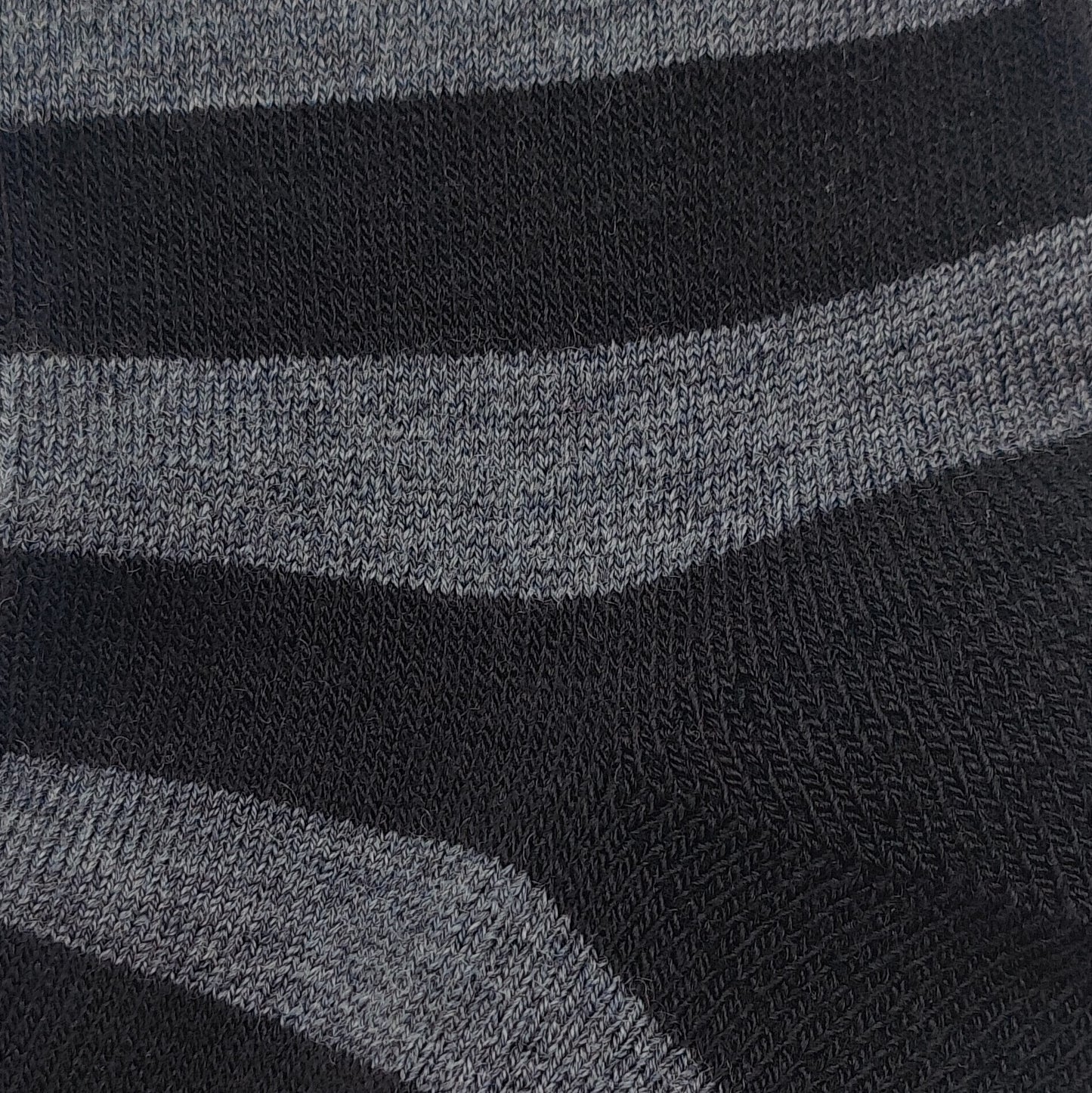 Close-up texture detail of Laetts black and gray Merino wool casual crew socks featuring patent-allowed HygroHeat™ thermal yarn.