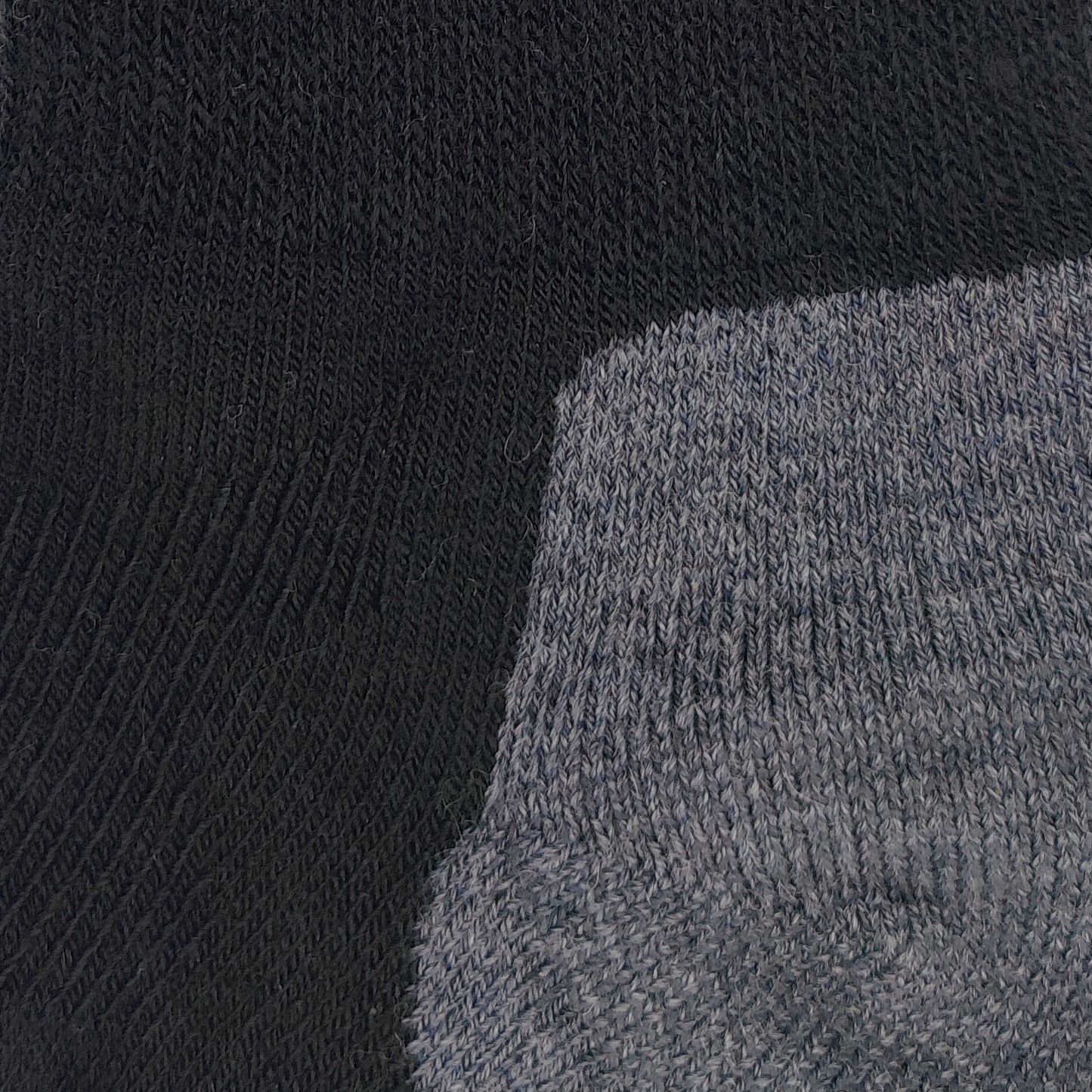 Close-up texture detail of Laetts black medium hiking crew socks made with Merino wool and patent-allowed HygroHeat™ thermal yarn.