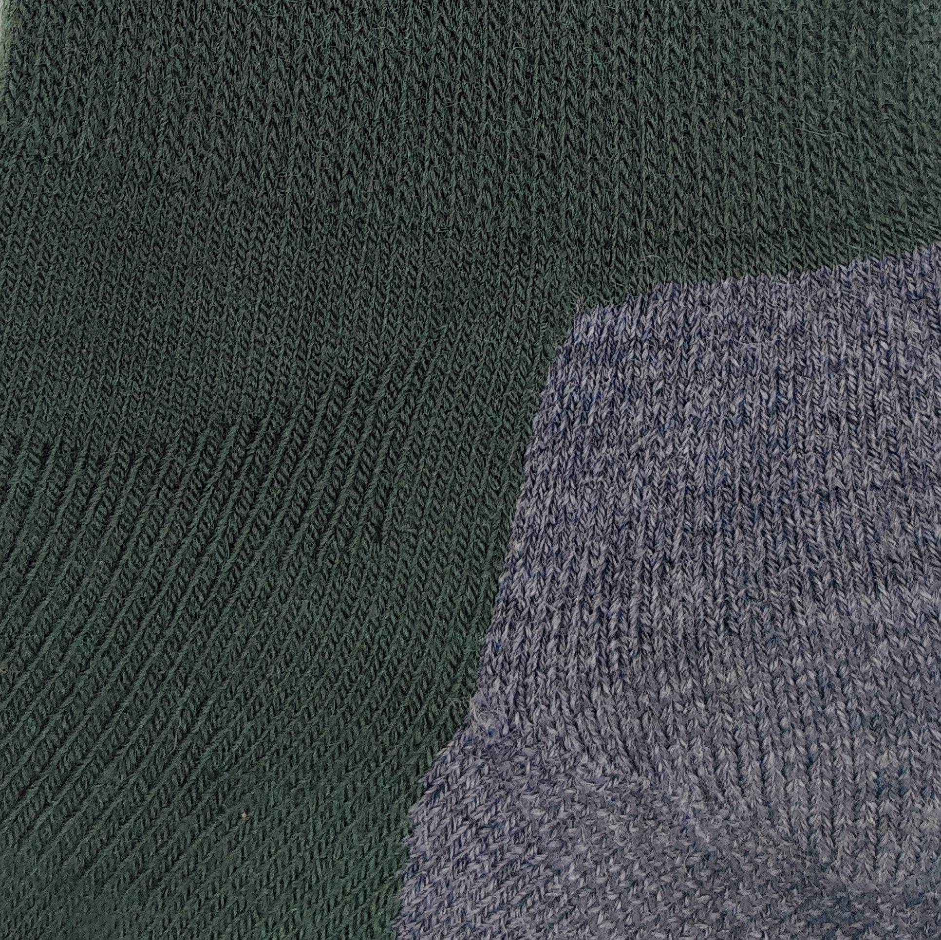 Close-up knit texture of Laetts green medium hiking crew socks made with Merino wool and patent-allowed HygroHeat™ thermal yarn.