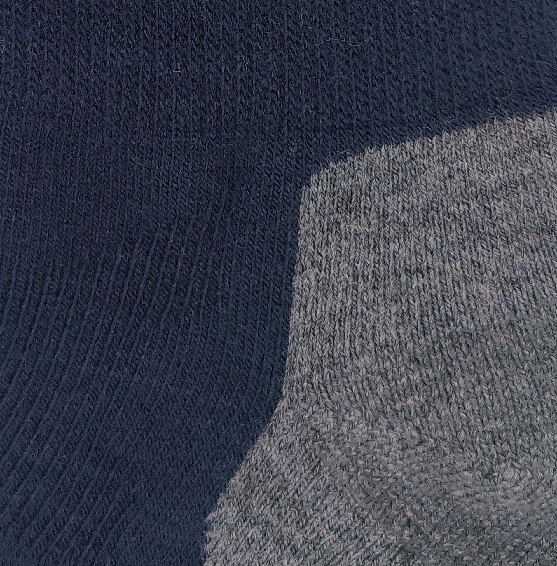 Close-up knit texture of Laetts navy medium hiking crew socks made with Merino wool and patent-allowed HygroHeat™ thermal yarn.