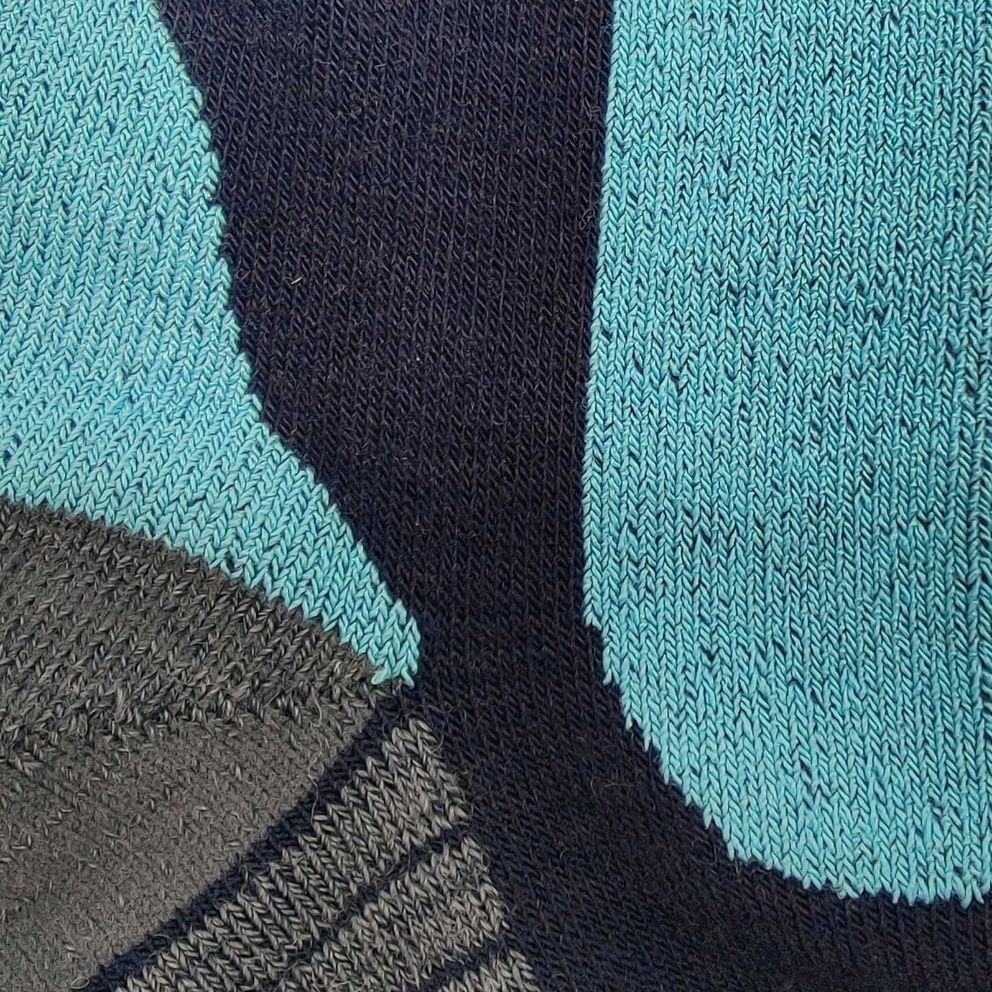 Close-up knit detail of Laetts ultralight OTC men’s ski socks showing Merino wool, HygroHeat™ thermal yarn, and BootGlide™ low-friction overlay